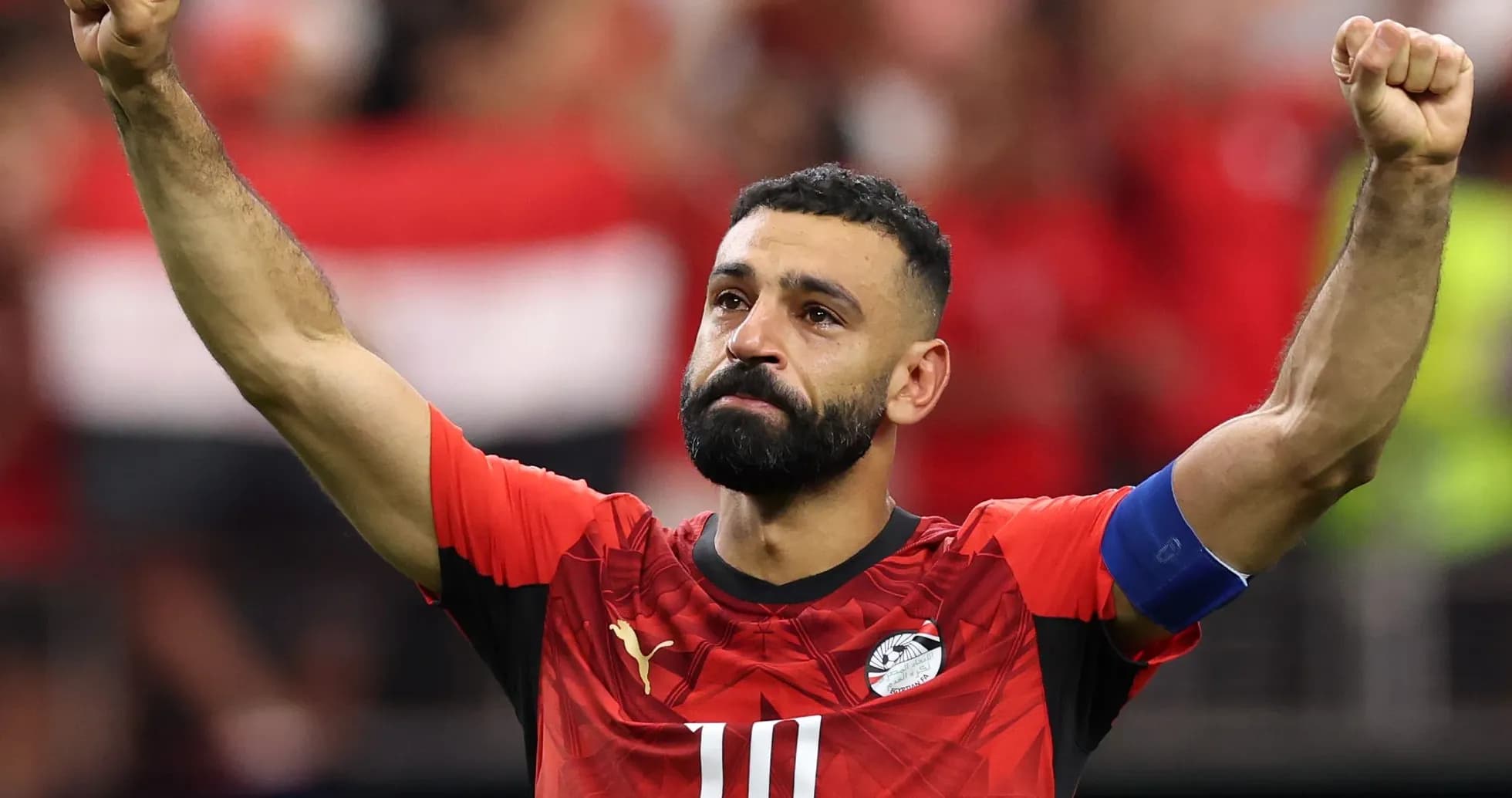 Player celebrating with raised fist in Egypt jersey Player celebrating with raised fist in Egypt jersey