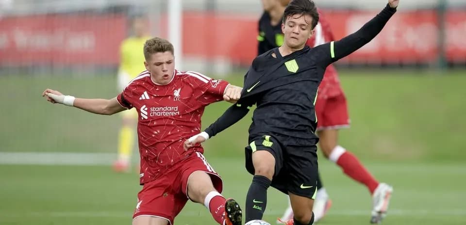 Two players competing for the ball during youth match Two players competing for the ball during youth match
