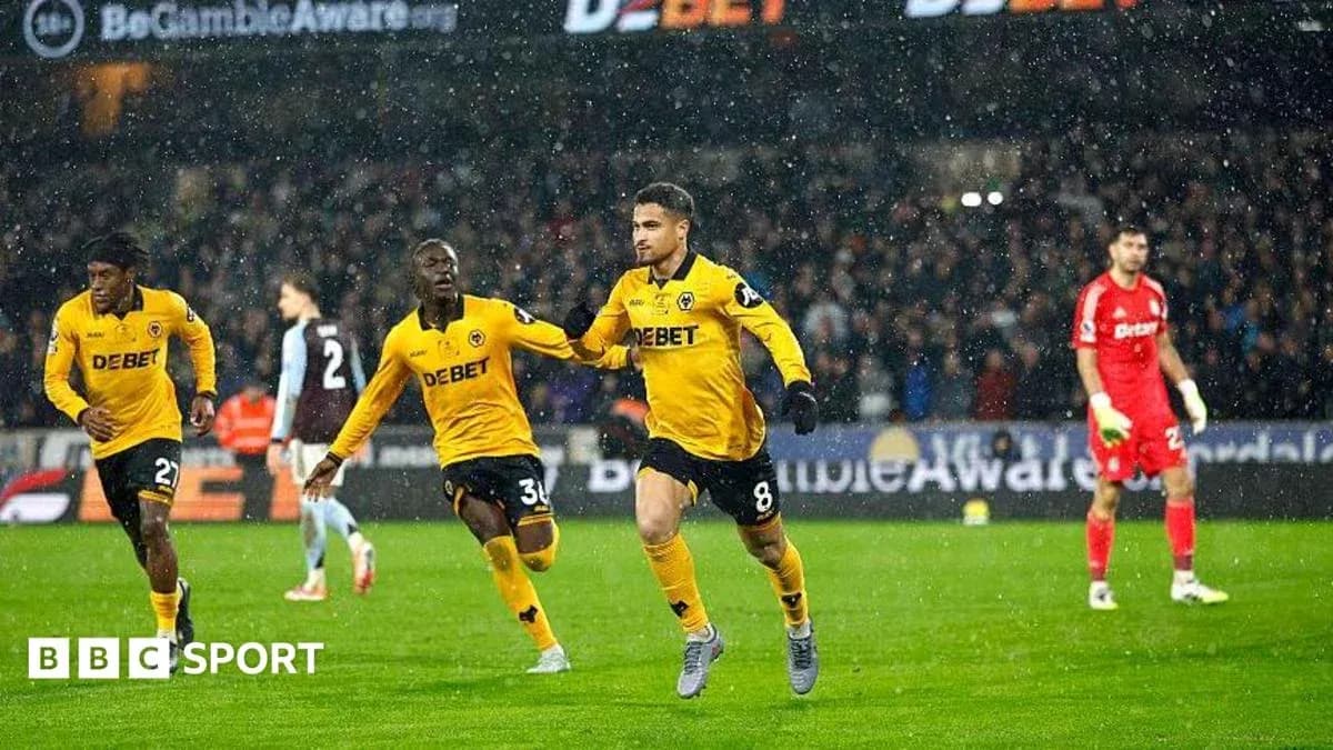 Player celebrating goal with teammates in rain Player celebrating goal with teammates in rain