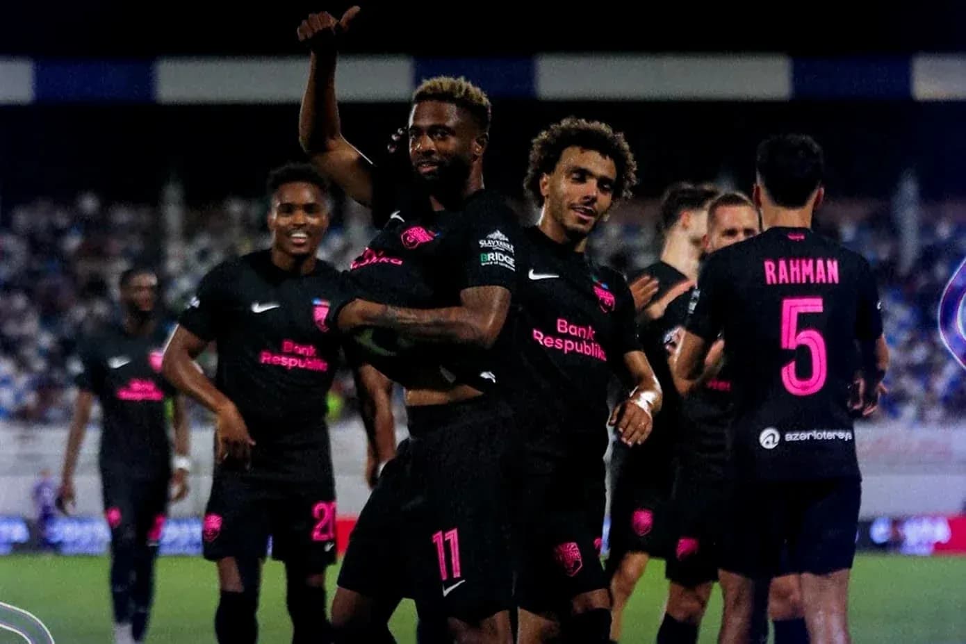 Players celebrating after a goal in football match Players celebrating after a goal in football match