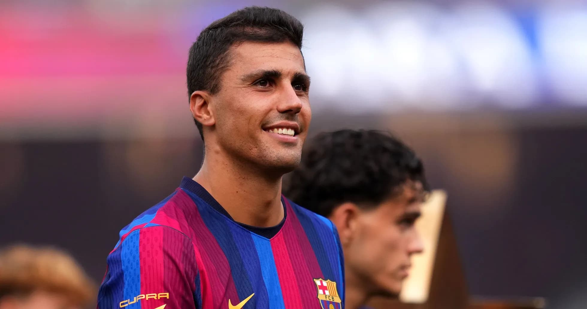 Player smiling while wearing Barcelona jersey Player smiling while wearing Barcelona jersey