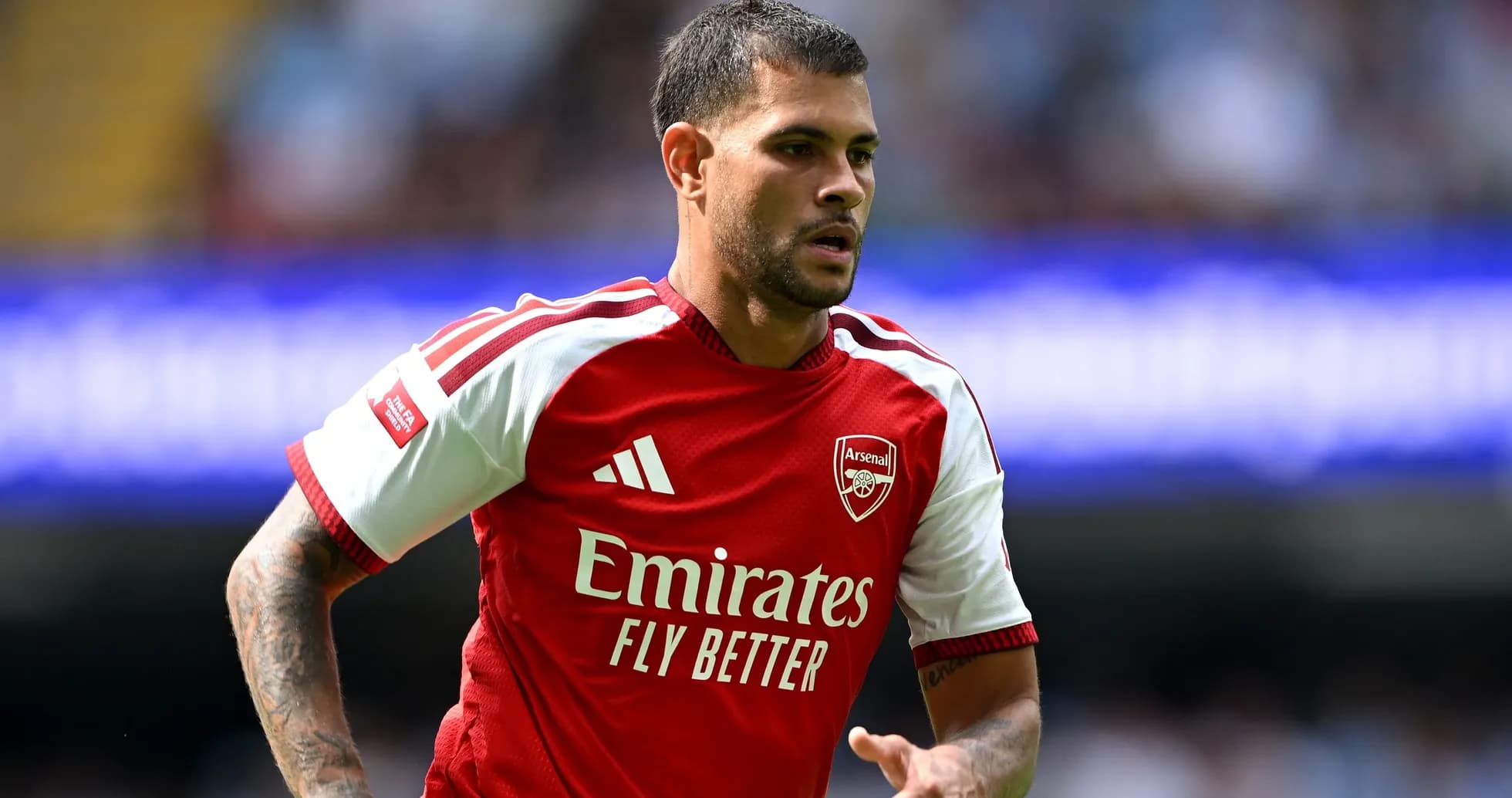 Player in Arsenal kit running on the pitch Player in Arsenal kit running on the pitch