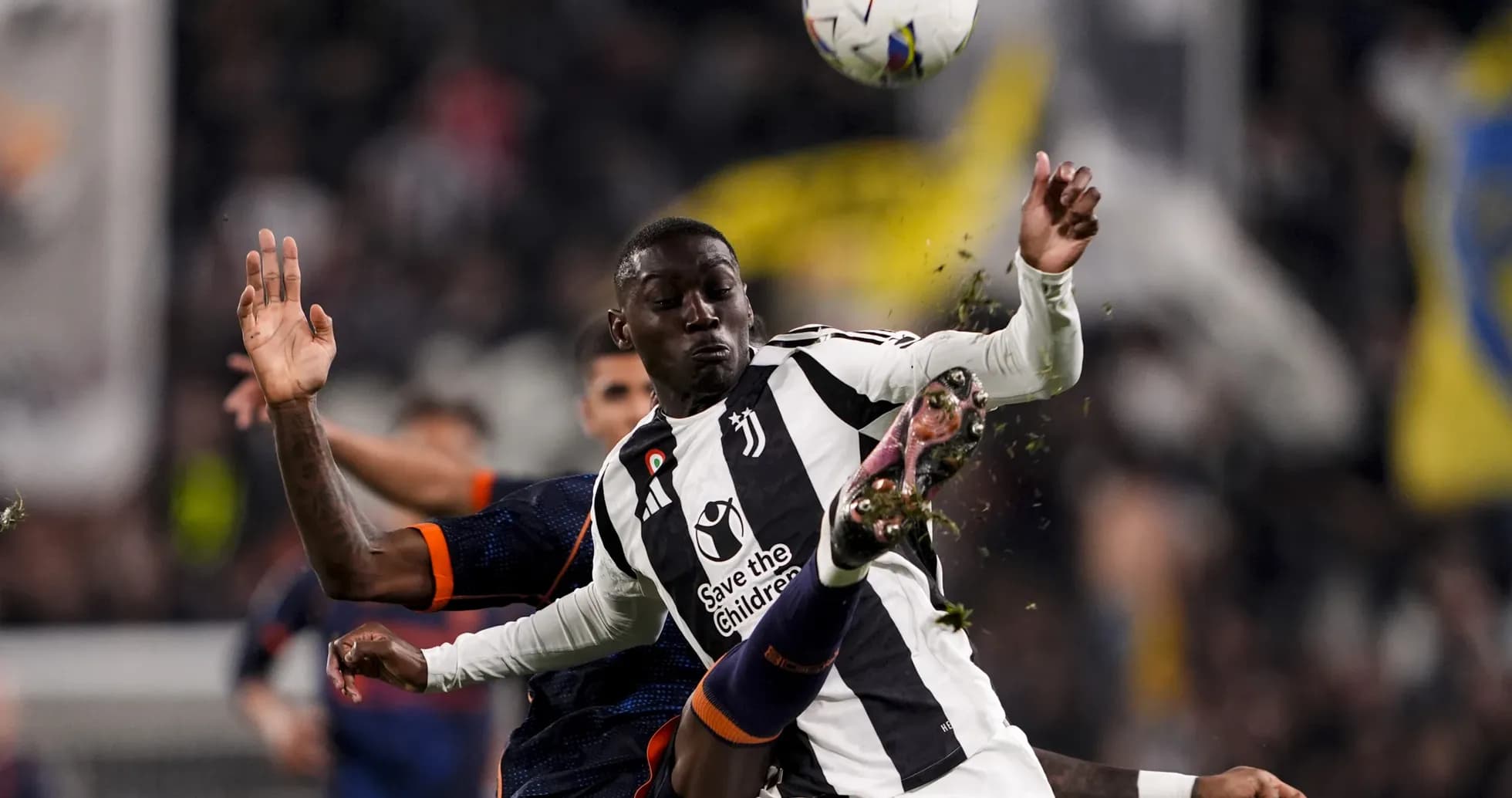 Juventus player challenging opponent during match Juventus player challenging opponent during match