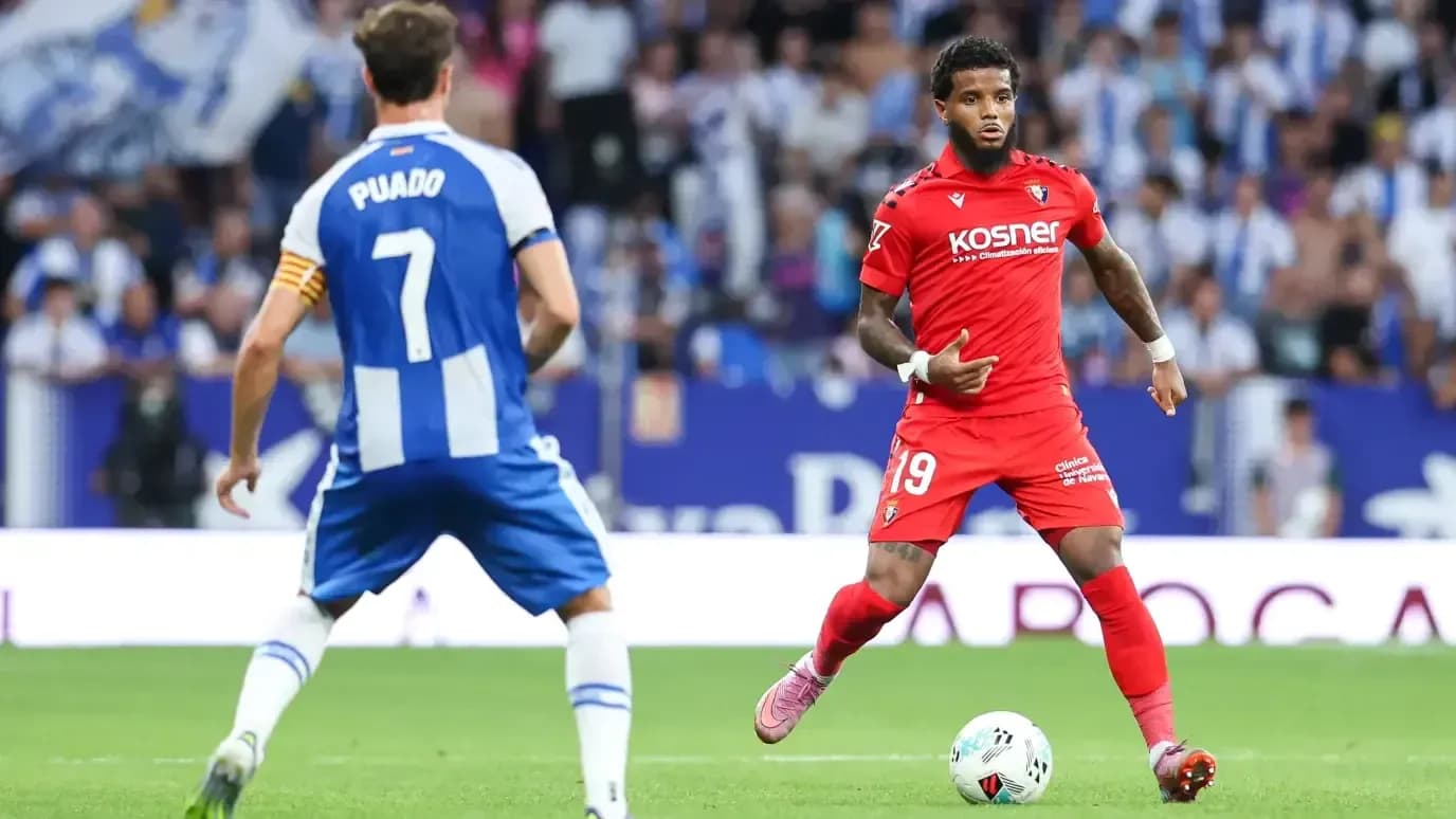 Osasuna player dribbling past Espanyol opponent Osasuna player dribbling past Espanyol opponent