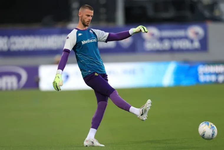 Goalkeeper practicing a kick during warm-up session Goalkeeper practicing a kick during warm-up session