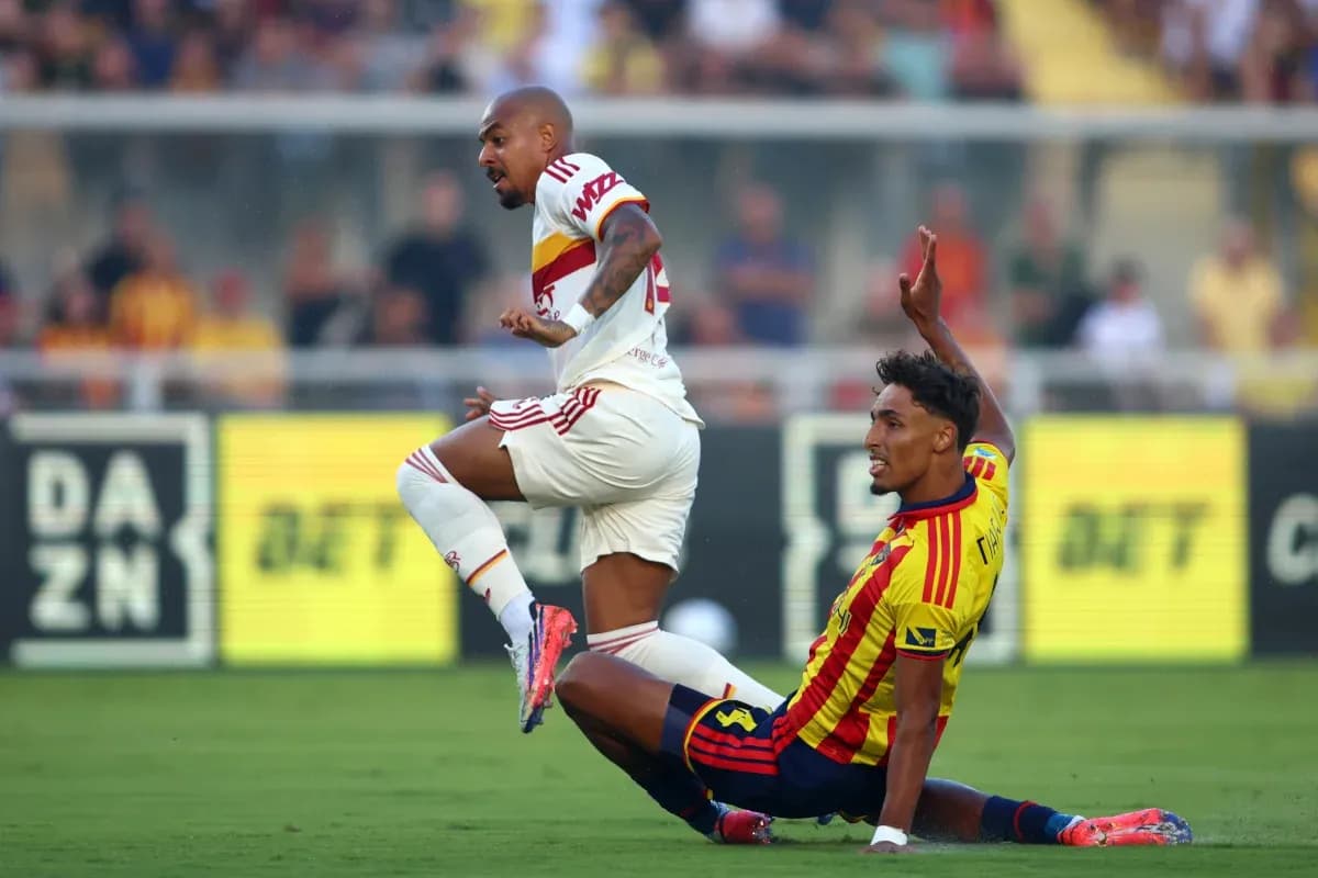 Player tackling opponent during Lecce vs AS Roma match Player tackling opponent during Lecce vs AS Roma match