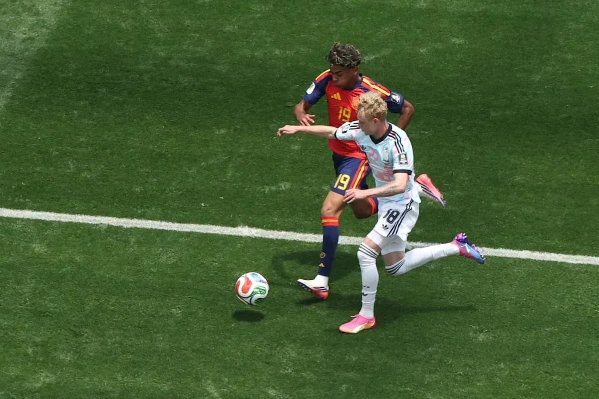 Two players battling for the ball on field Two players battling for the ball on field
