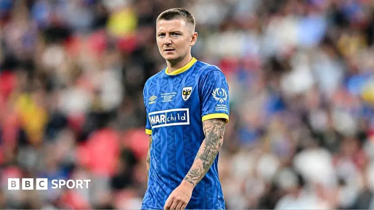 Player wearing blue kit on football pitch Player wearing blue kit on football pitch