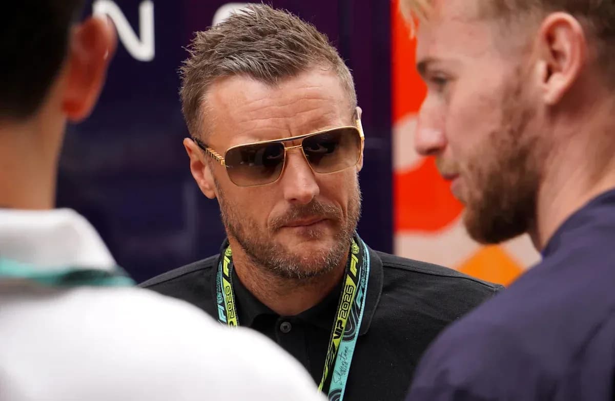 Man wearing sunglasses conversing with two others Man wearing sunglasses conversing with two others
