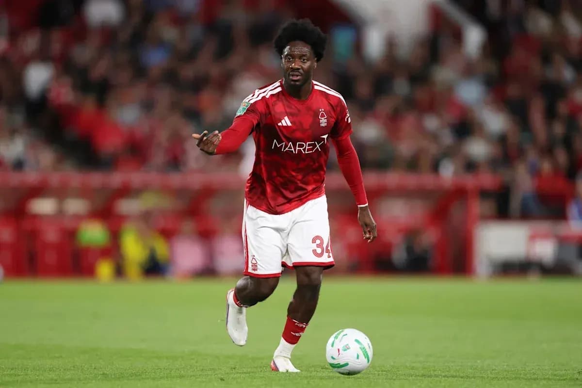 Player in red kit directing play on the field Player in red kit directing play on the field
