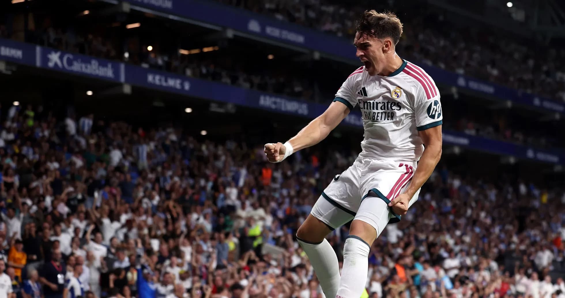 Player celebrating a goal in stadium crowd Player celebrating a goal in stadium crowd