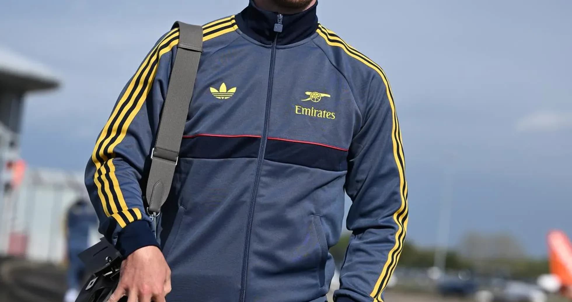 Athlete in tracksuit walking with a bag Athlete in tracksuit walking with a bag