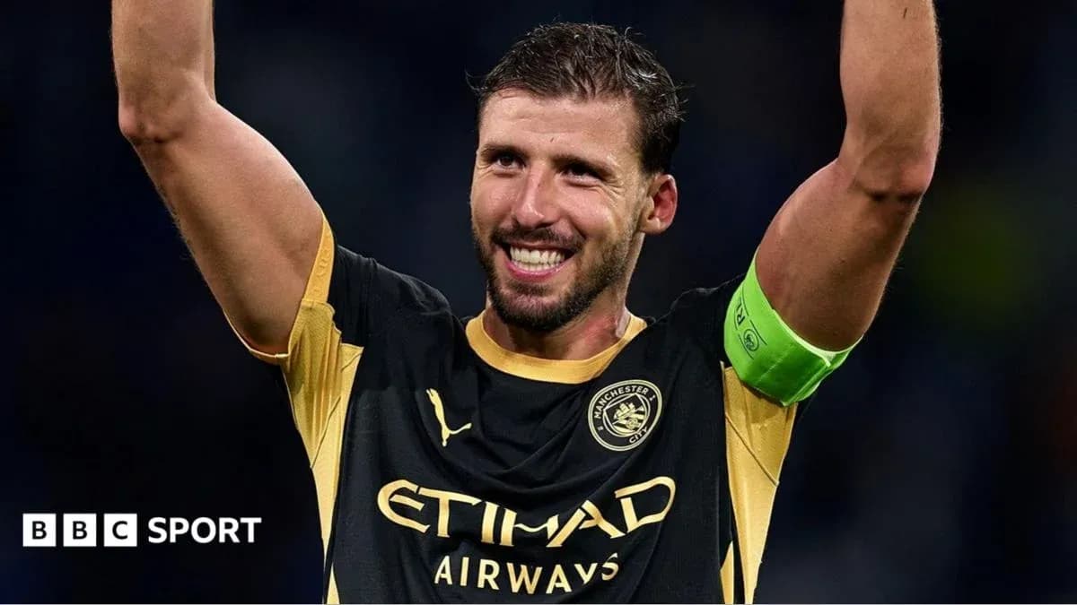 Player celebrating with raised arms in Manchester City kit Player celebrating with raised arms in Manchester City kit