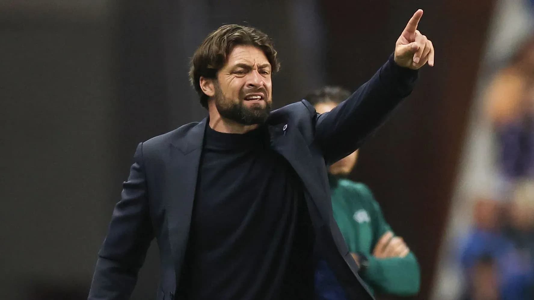 Coach gesturing during a match from the sidelines Coach gesturing during a match from the sidelines