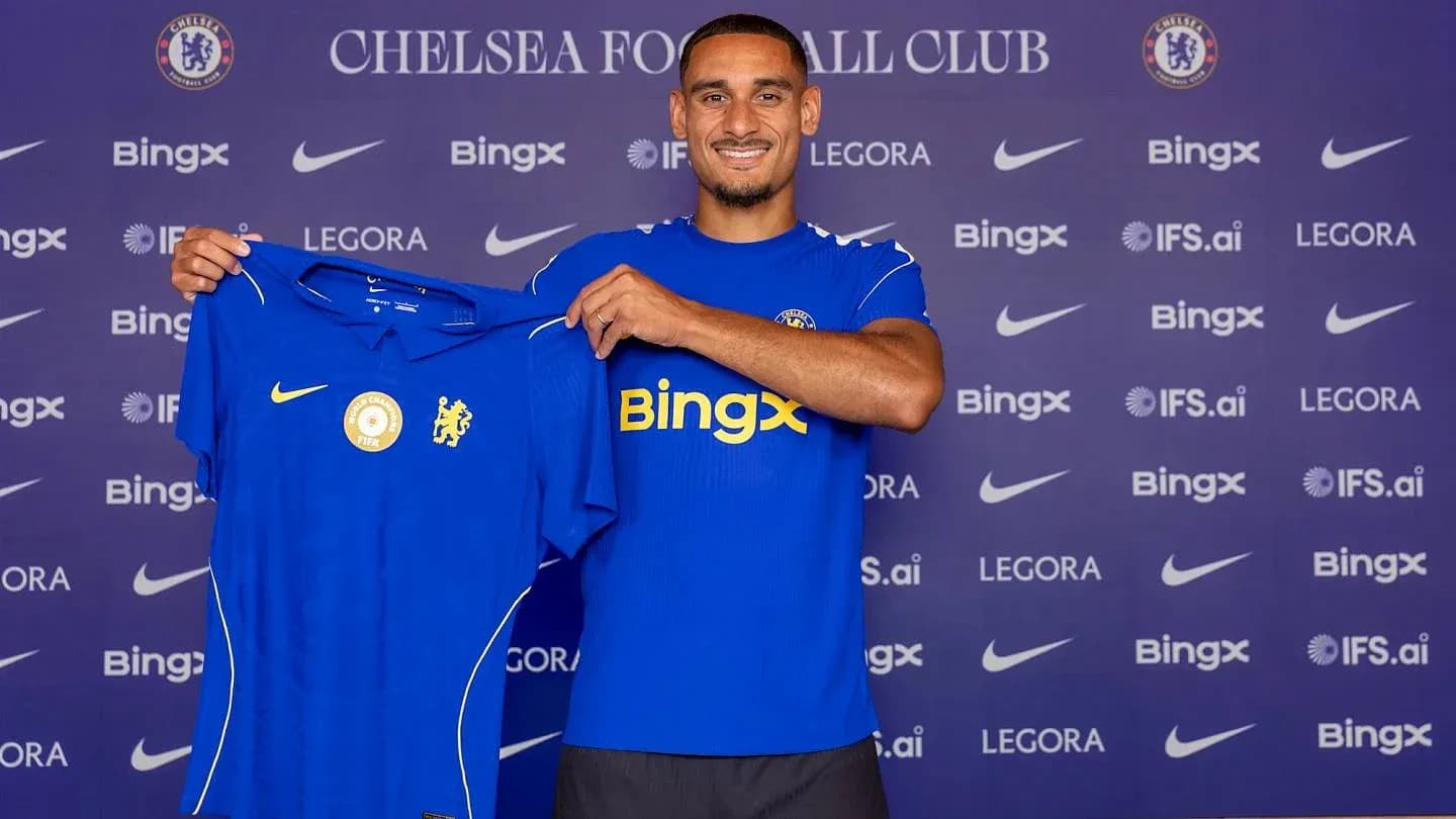 Player holding Chelsea jersey at press event Player holding Chelsea jersey at press event