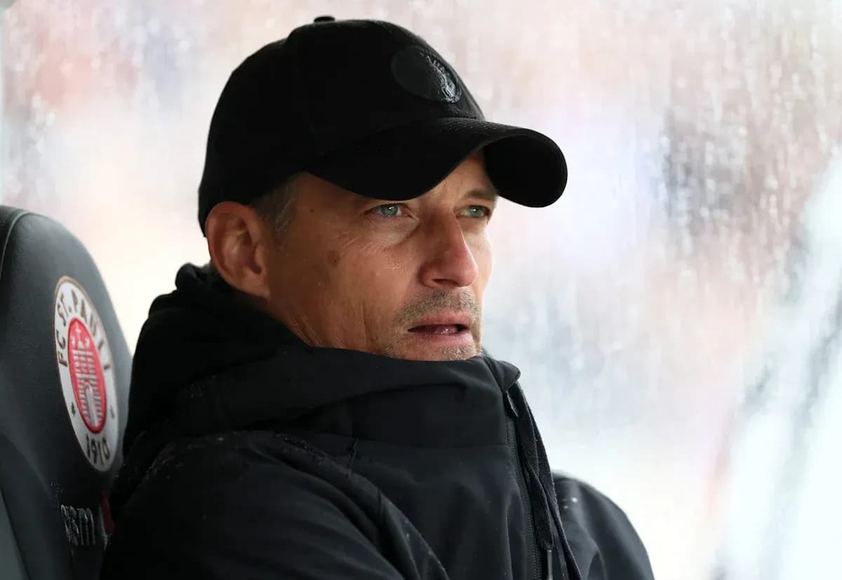 Coach observing match from the sidelines in rain Coach observing match from the sidelines in rain