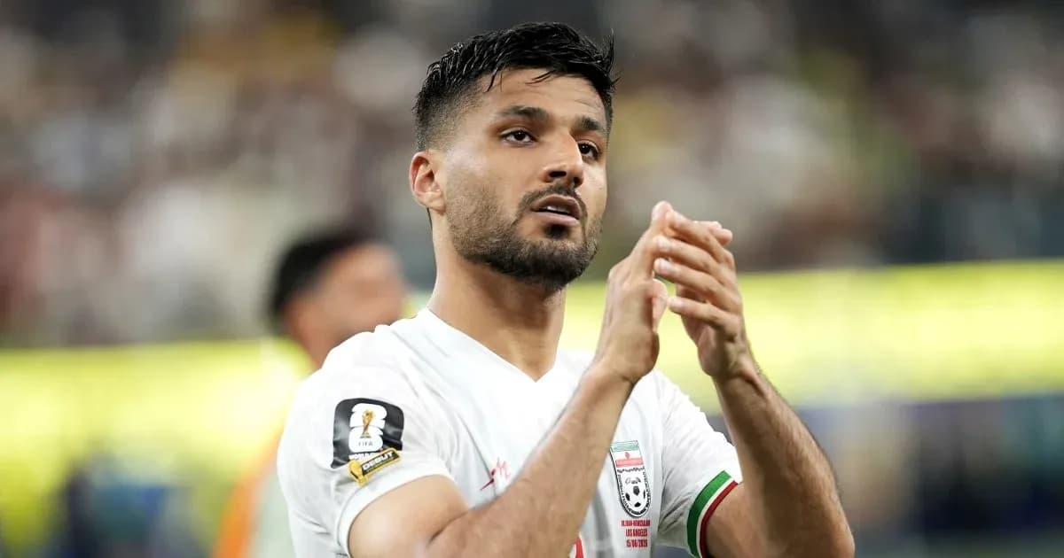 Player applauding fans during a football match Player applauding fans during a football match