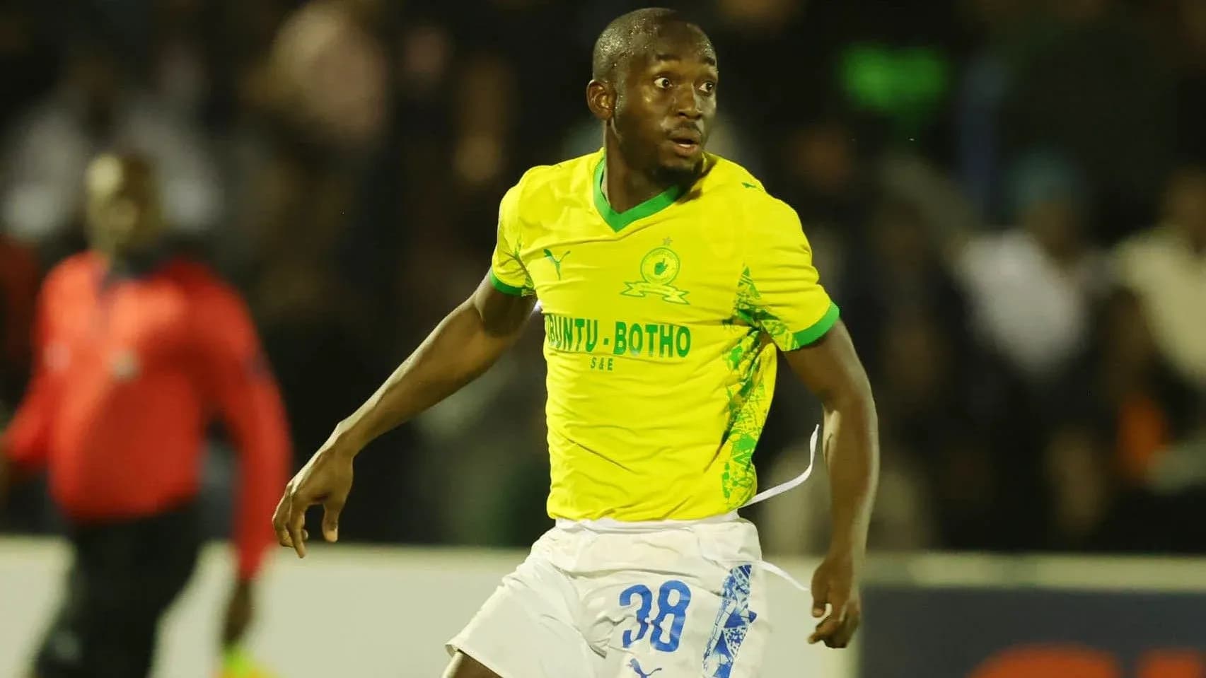 Player in yellow jersey during a football match Player in yellow jersey during a football match