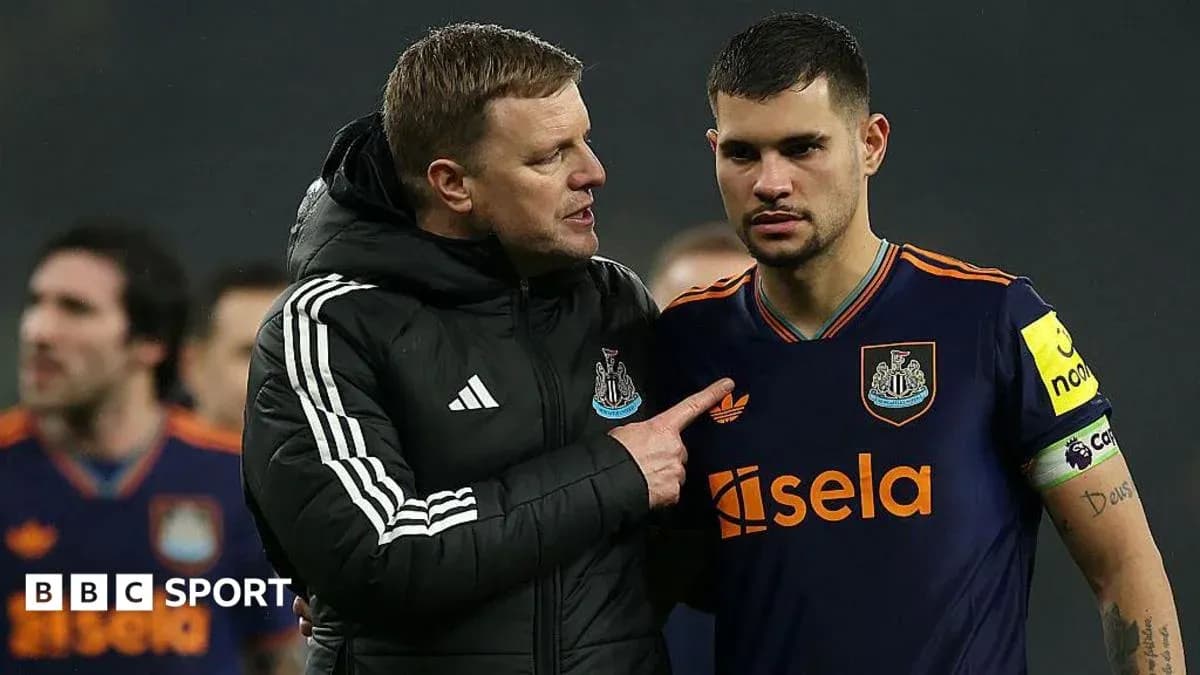 Newcastle United manager speaking to player on pitch Newcastle United manager speaking to player on pitch