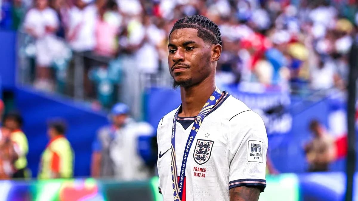 Player in England jersey with medal on pitch Player in England jersey with medal on pitch