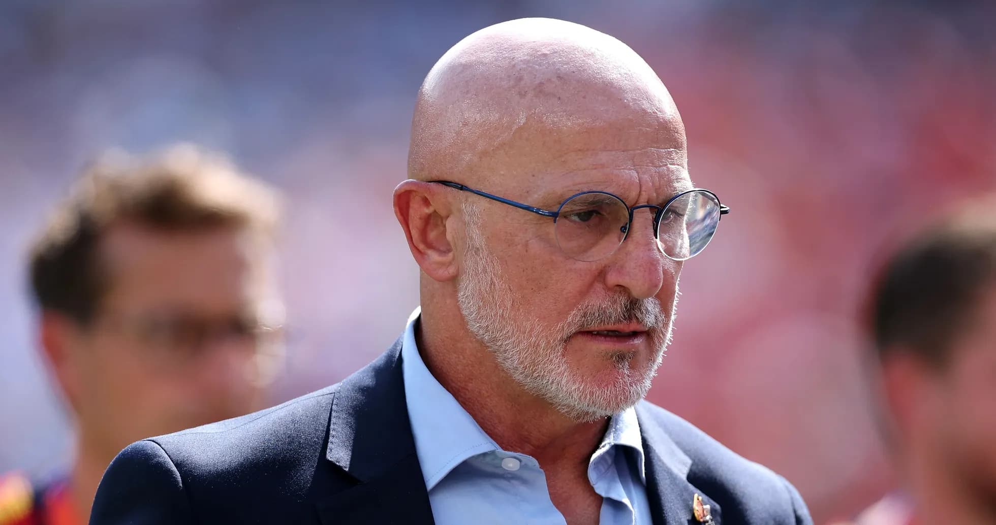 Man in suit and glasses on the sidelines Man in suit and glasses on the sidelines