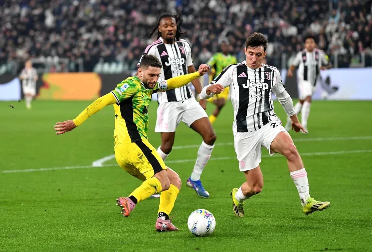 Juventus player tackling opponent during Serie A match Juventus player tackling opponent during Serie A match