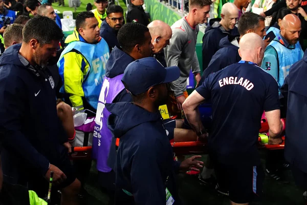 Medical staff assisting injured player off the field Medical staff assisting injured player off the field