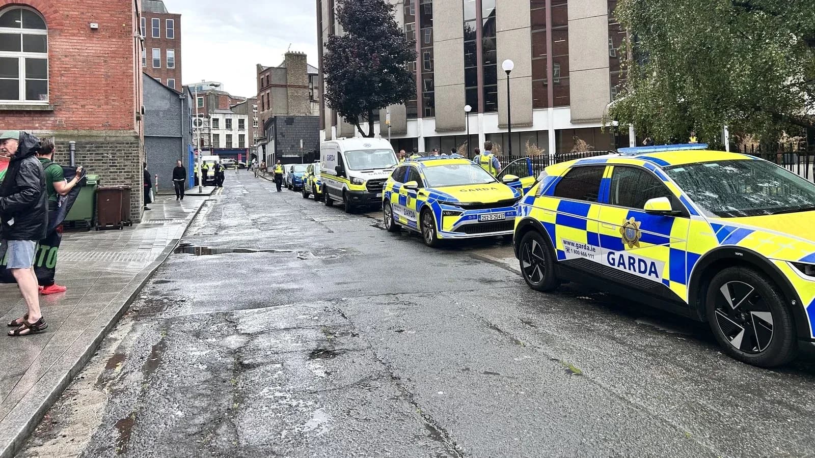 Garda vehicles parked on a wet street Garda vehicles parked on a wet street