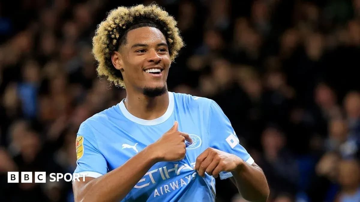 Player celebrating with thumbs up in Manchester City kit Player celebrating with thumbs up in Manchester City kit