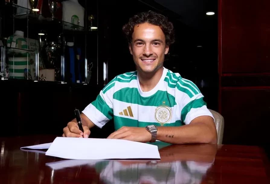 Player signing contract while wearing team jersey Player signing contract while wearing team jersey
