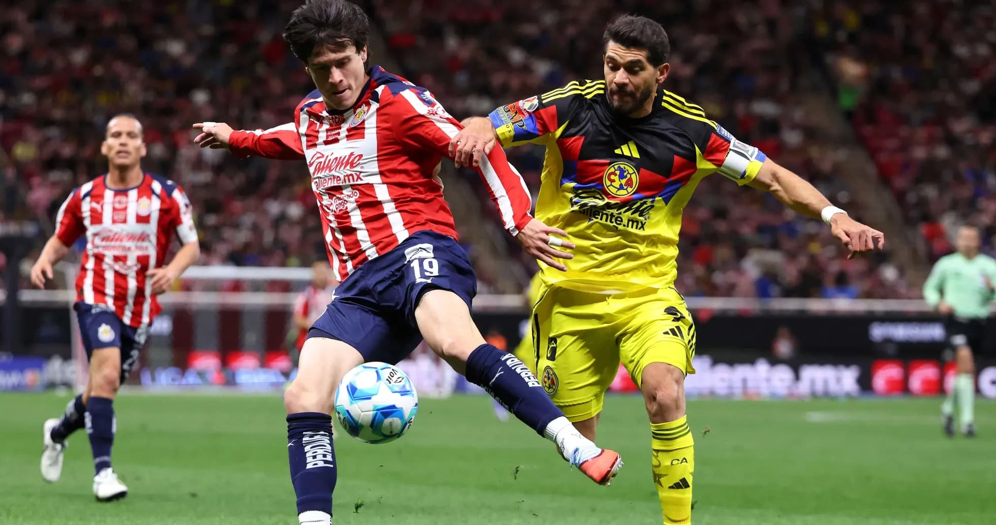 Chivas player challenging Club America goalkeeper Chivas player challenging Club America goalkeeper