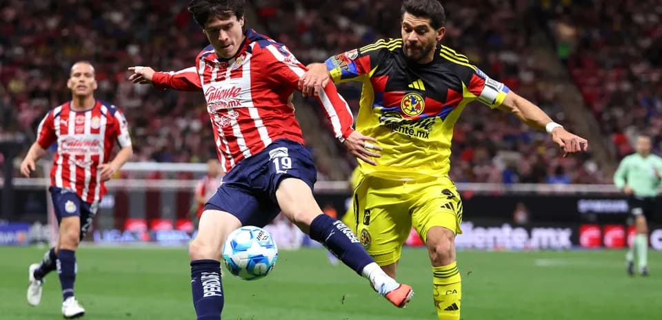 Chivas player challenging Club America goalkeeper Chivas player challenging Club America goalkeeper