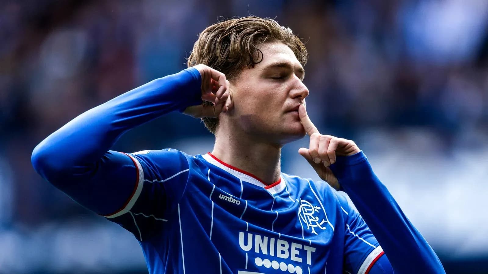 Player celebrating with shushing gesture after scoring Player celebrating with shushing gesture after scoring