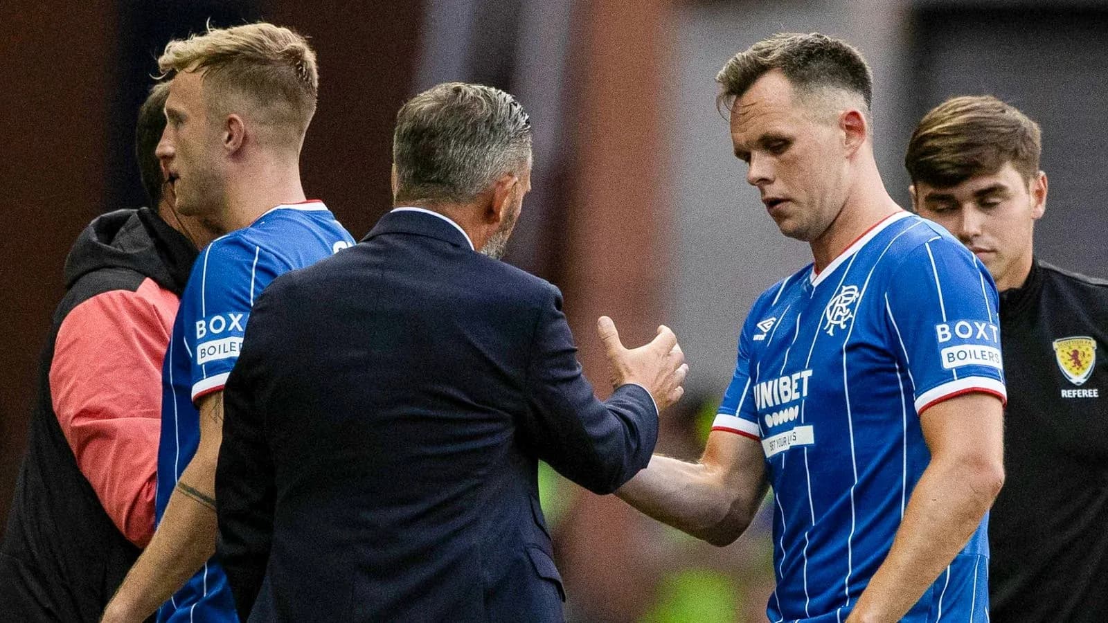 Rangers players interacting with coach during substitution Rangers players interacting with coach during substitution