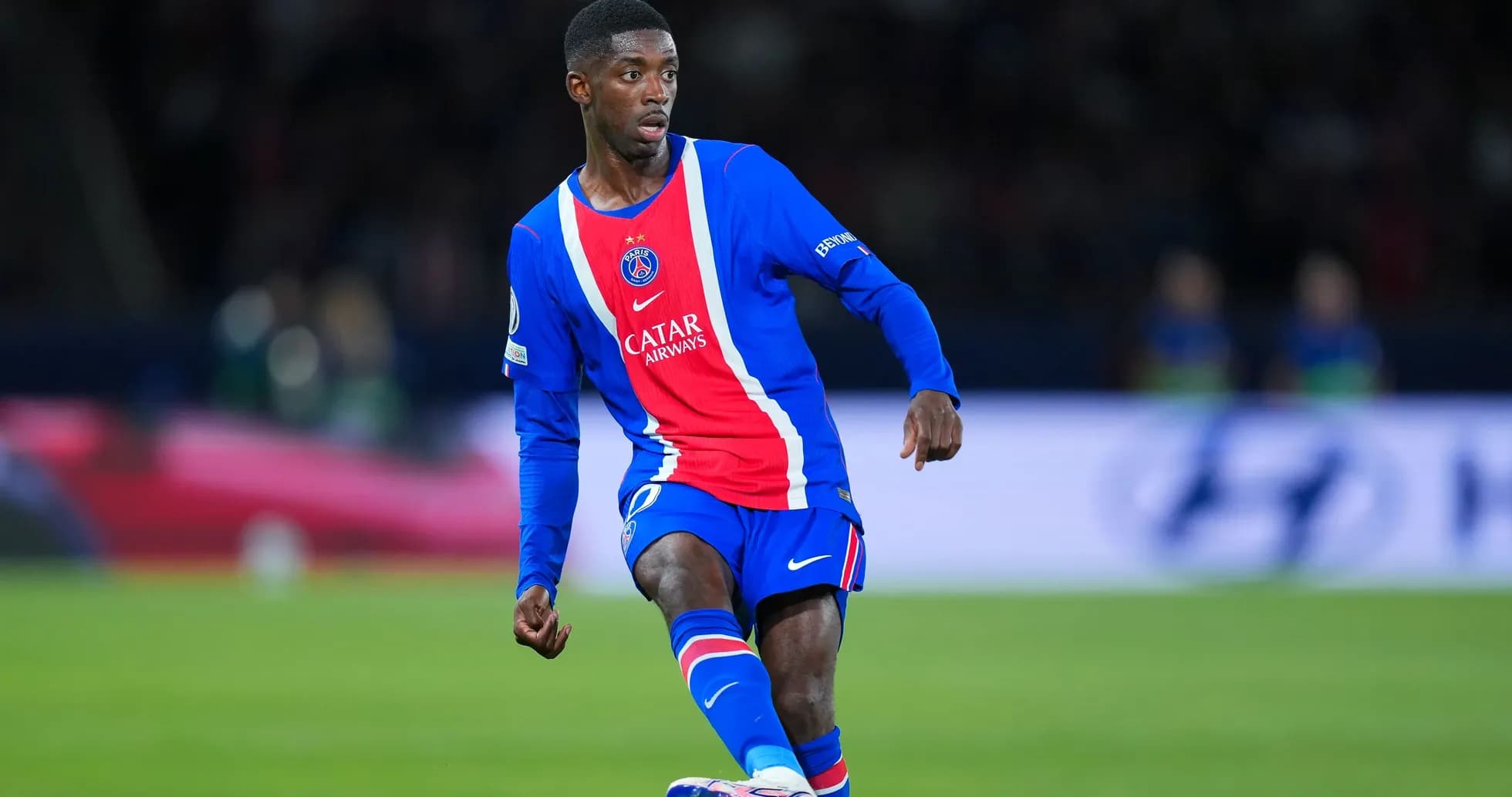Player in PSG kit dribbling during match Player in PSG kit dribbling during match