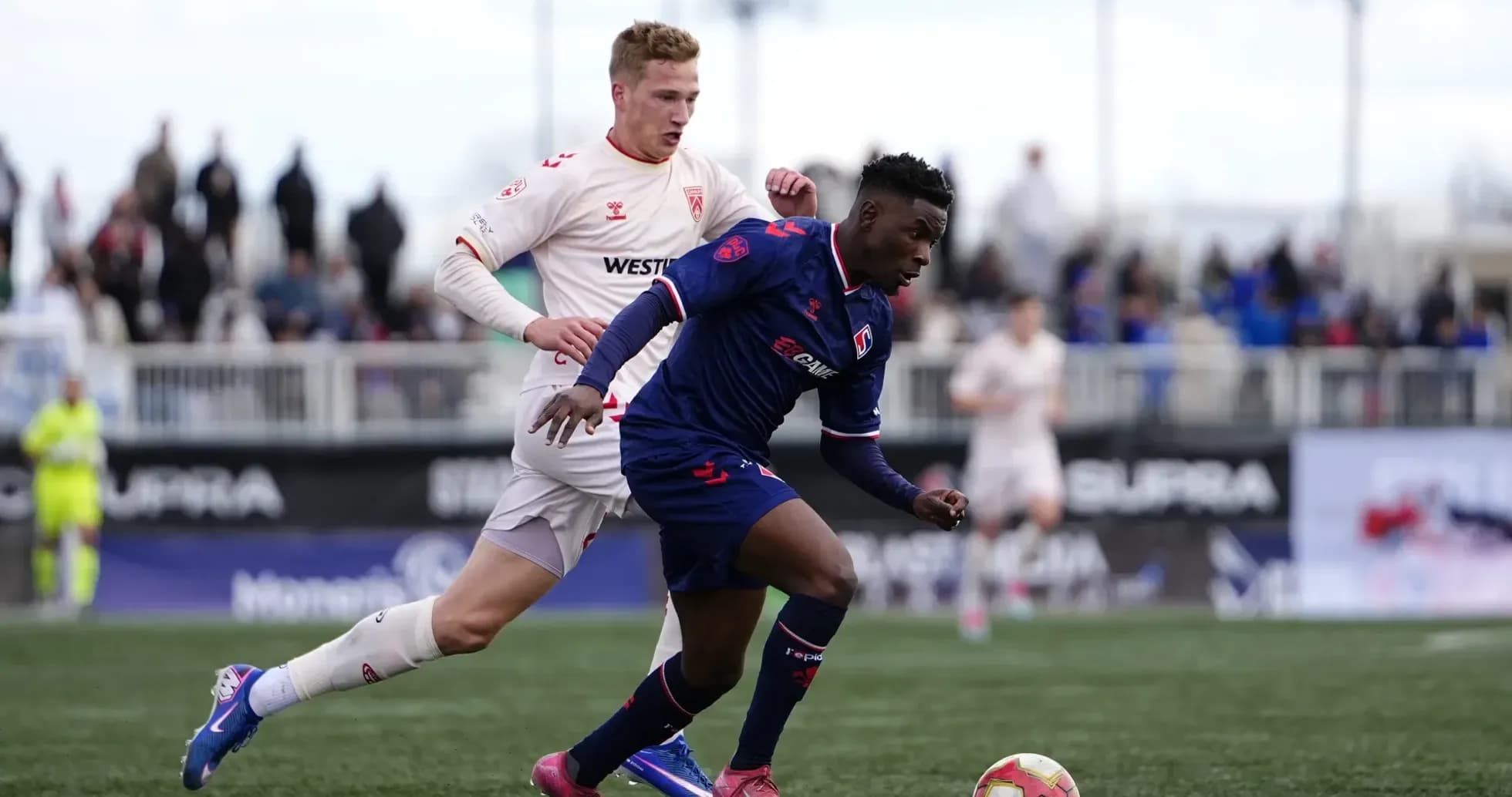 Cavalry FC player dribbling past opponent Cavalry FC player dribbling past opponent