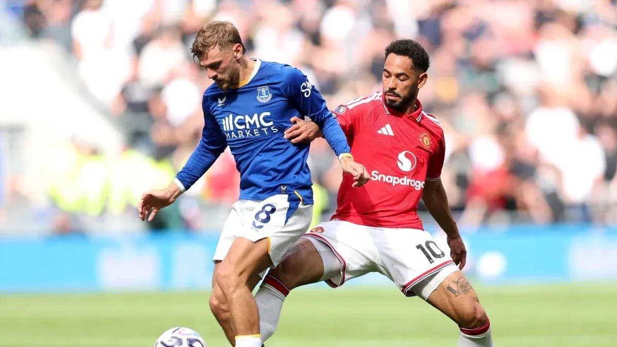 Everton player challenged by Manchester United opponent Everton player challenged by Manchester United opponent