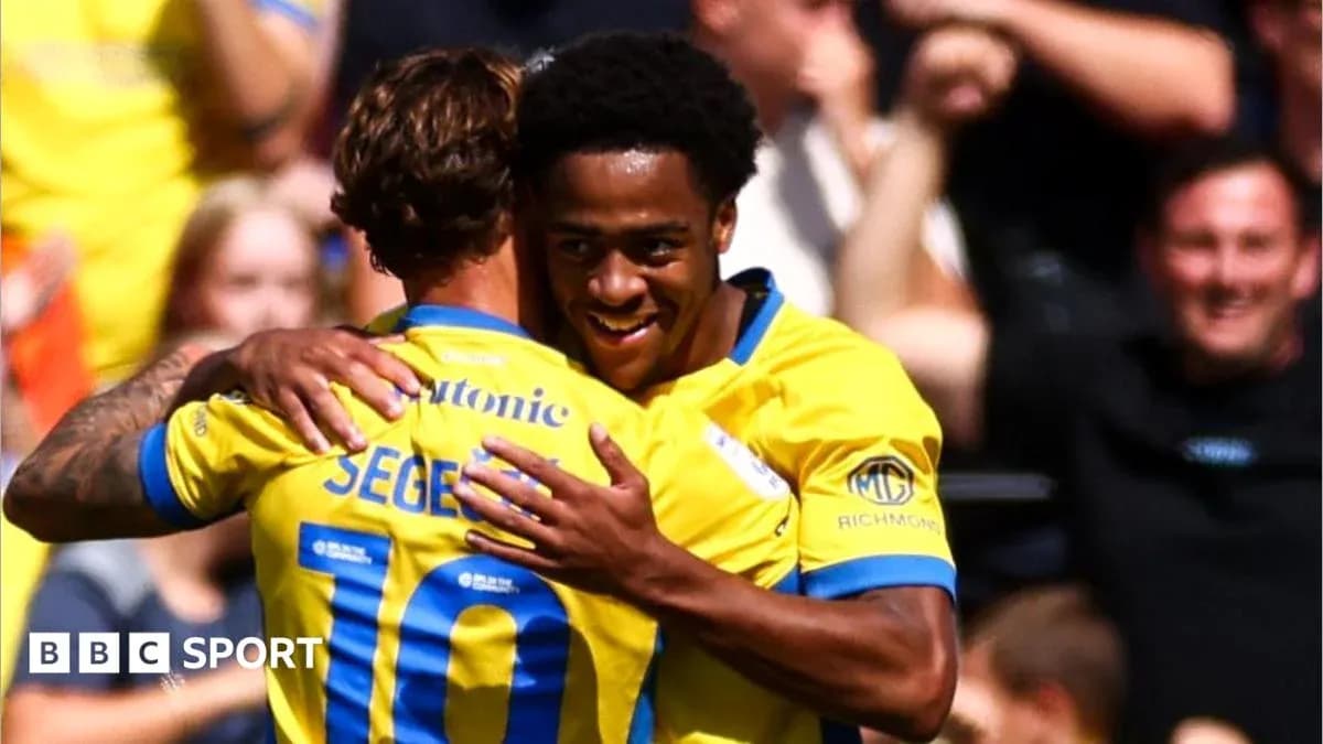 Two players celebrating a goal with embrace Two players celebrating a goal with embrace