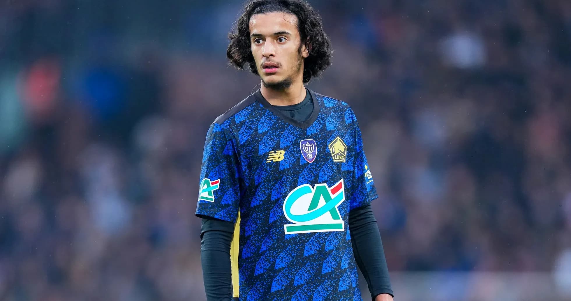 Player wearing blue jersey during a match Player wearing blue jersey during a match