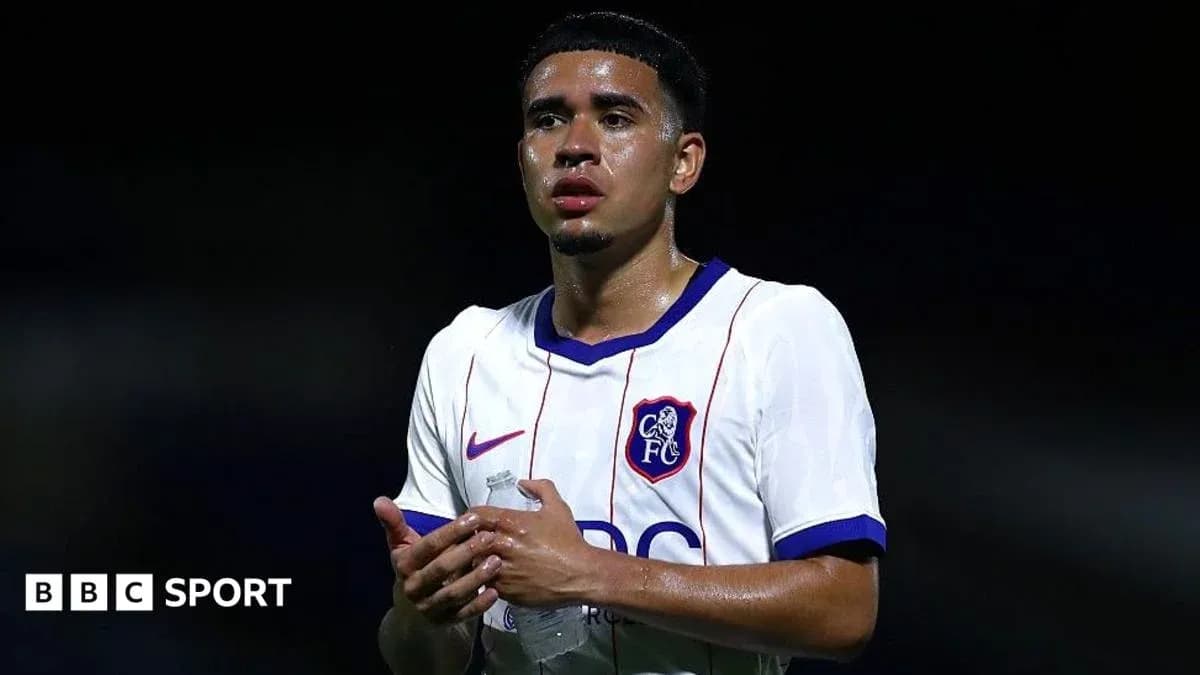 Player in white jersey holding water bottle Player in white jersey holding water bottle