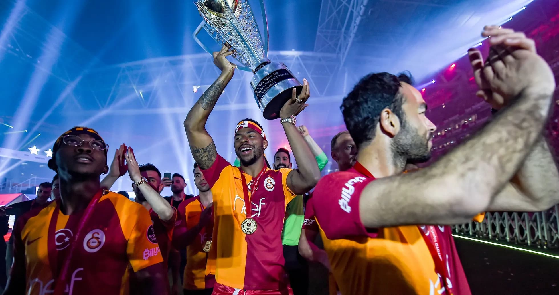 Player celebrating with trophy and teammates after victory Player celebrating with trophy and teammates after victory
