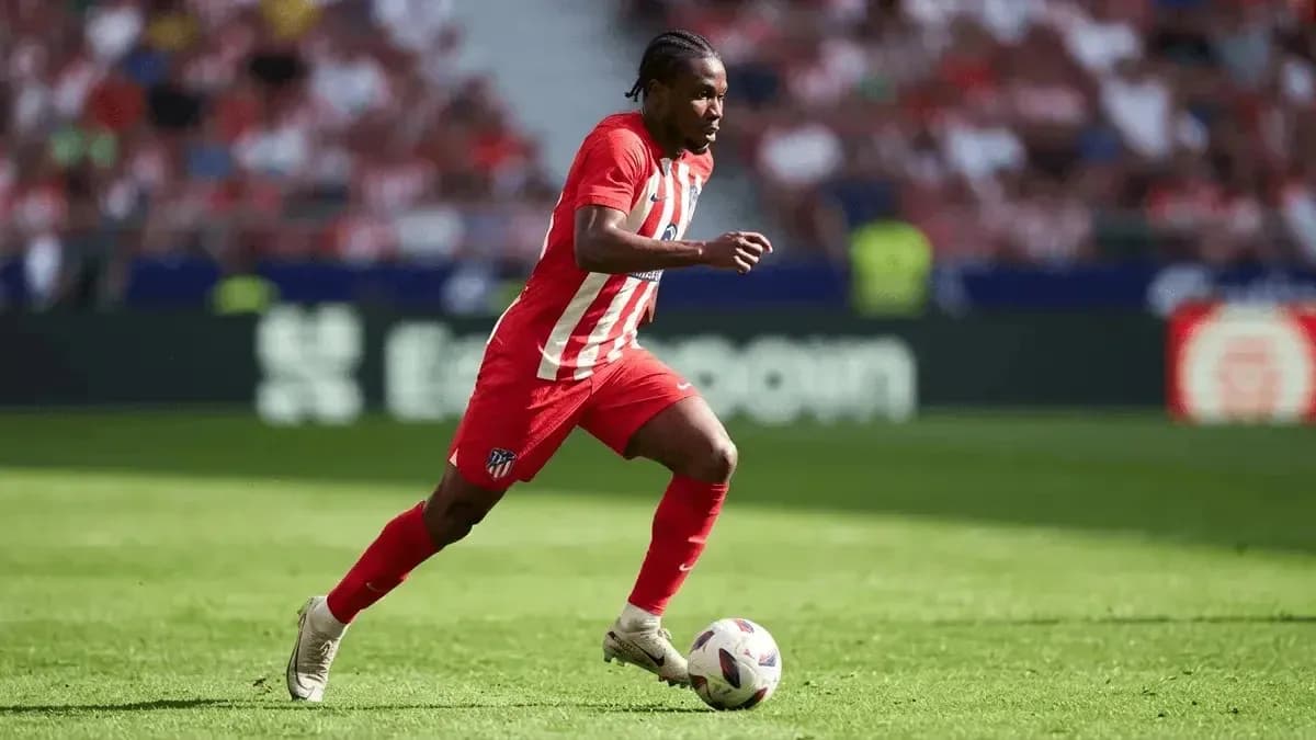 Atletico Madrid player dribbling the ball on field Atletico Madrid player dribbling the ball on field