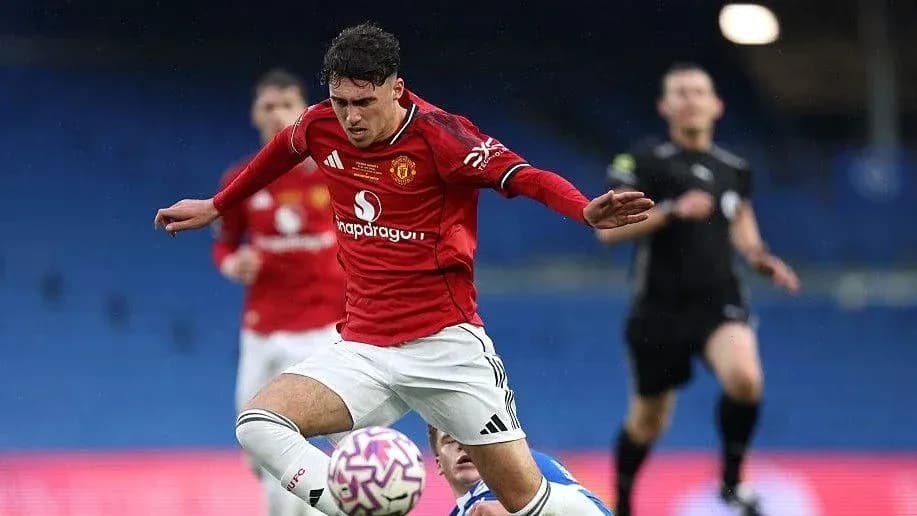 Player from Manchester United sliding for the ball Player from Manchester United sliding for the ball