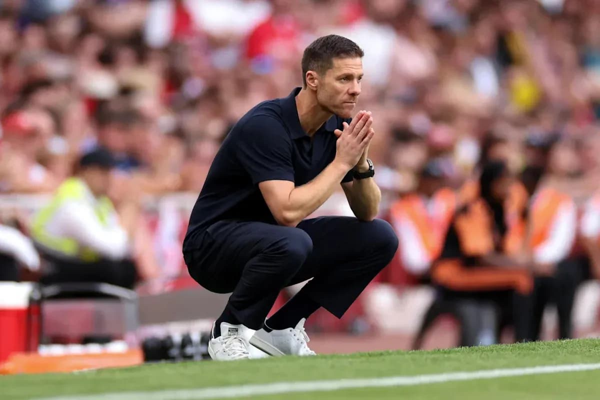 Coach observing match while crouching on sidelines Coach observing match while crouching on sidelines
