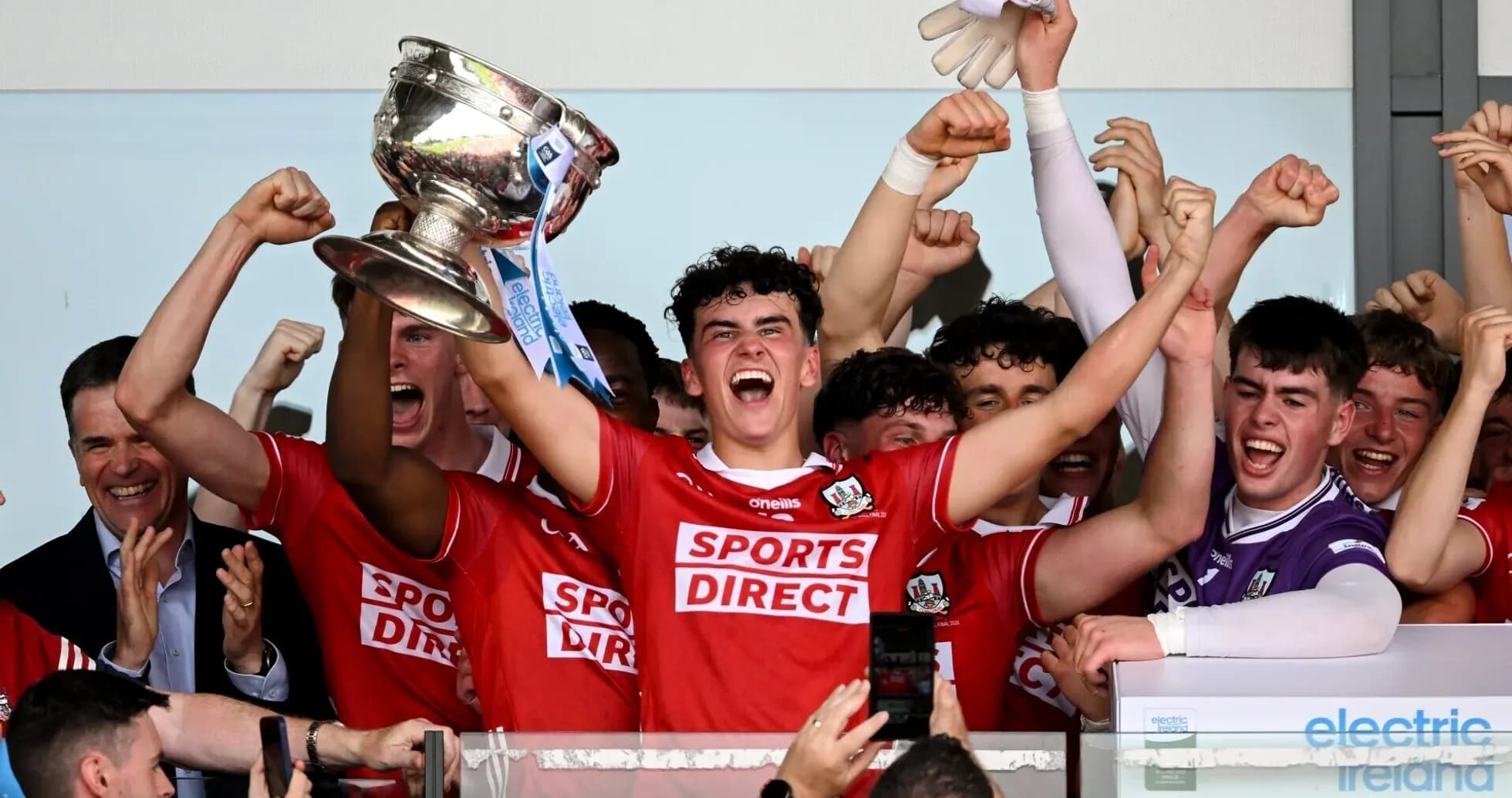 Players celebrating with trophy after winning match Players celebrating with trophy after winning match