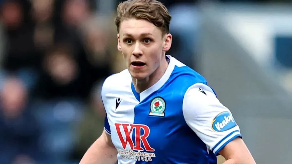 Player in Blackburn Rovers kit running on the field Player in Blackburn Rovers kit running on the field