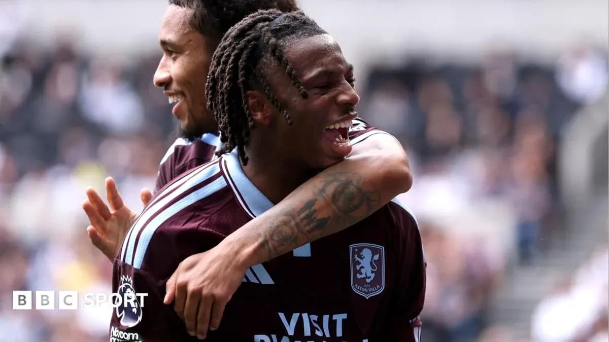 Two Aston Villa players celebrating a goal Two Aston Villa players celebrating a goal