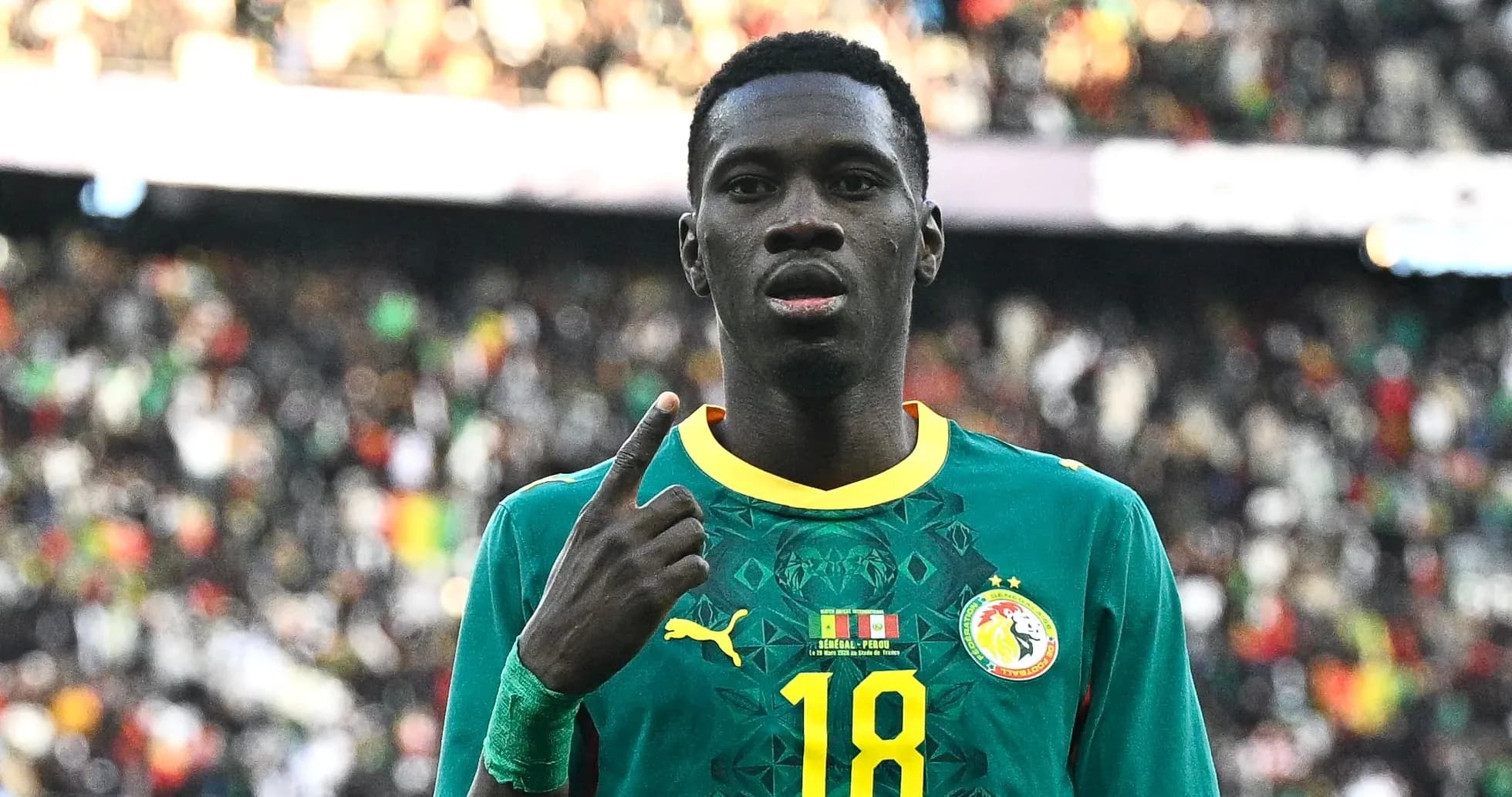 Player in Senegal jersey celebrating with finger raised Player in Senegal jersey celebrating with finger raised