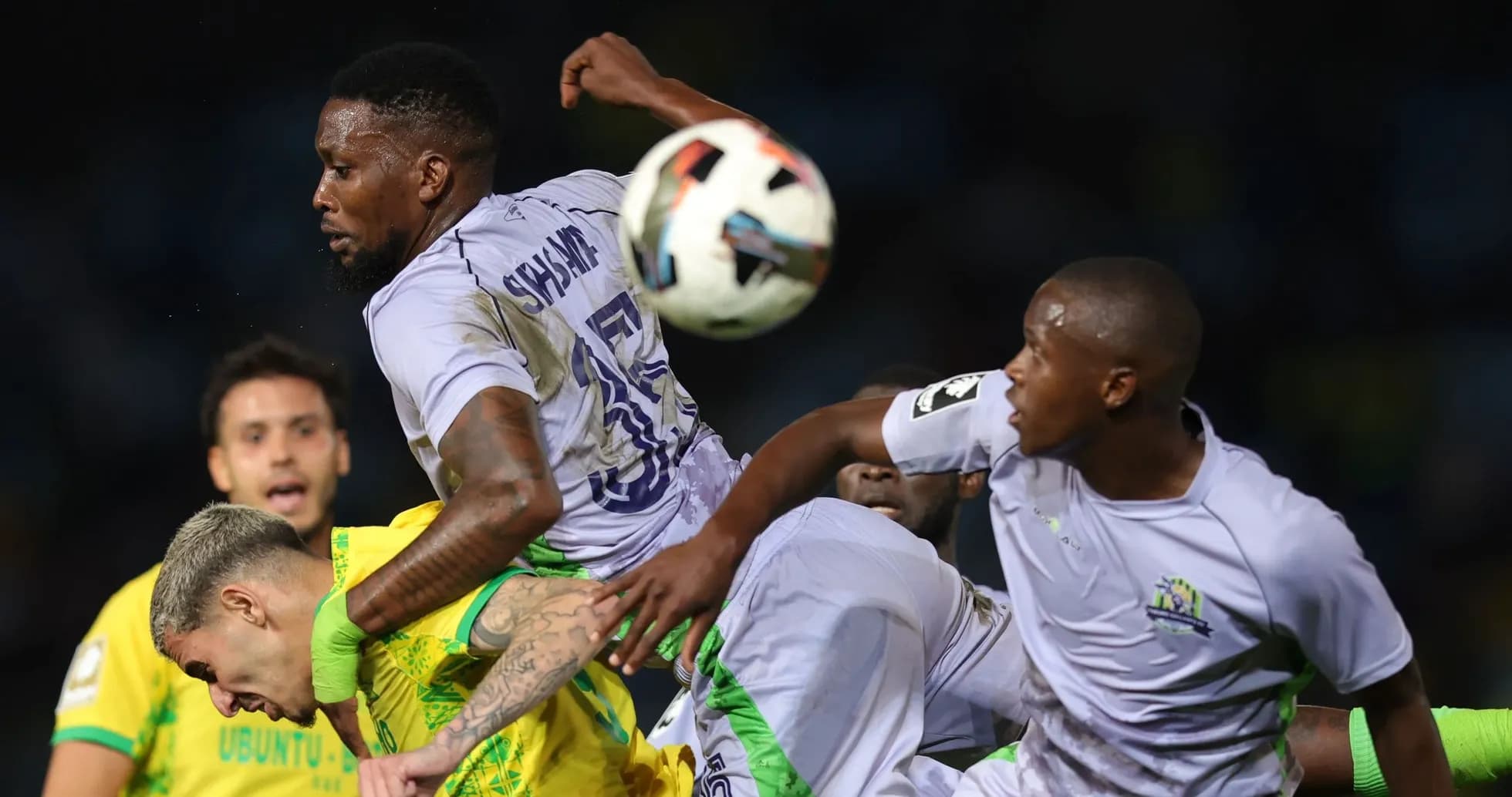 Players contesting for the ball during a match Players contesting for the ball during a match