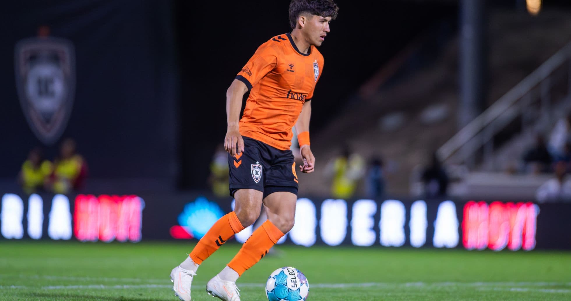 Player from Orange County SC dribbling the ball Player from Orange County SC dribbling the ball